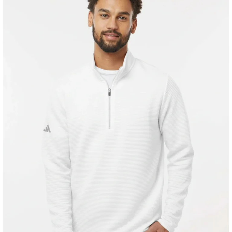 Man in white Adidas golf quarter-zip pullover with textured fabric