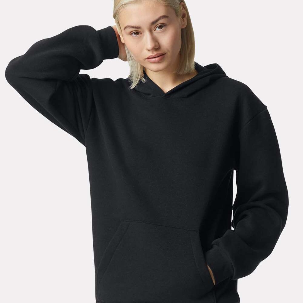 Woman wearing a black hoodie with a front pocket and hood