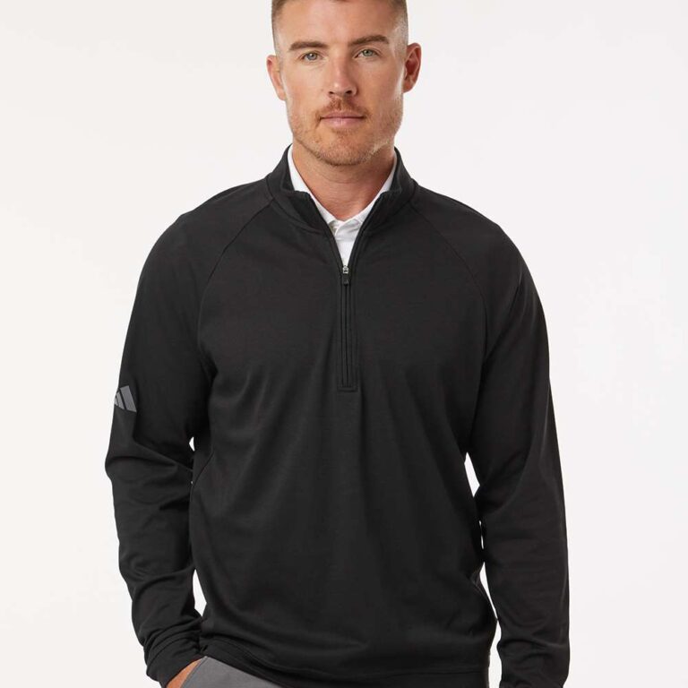 Man in black Adidas golf pullover with grey pants
