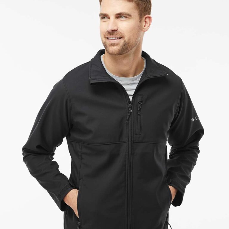 Man in black Columbia softshell jacket with zipped pockets and logo on sleeve