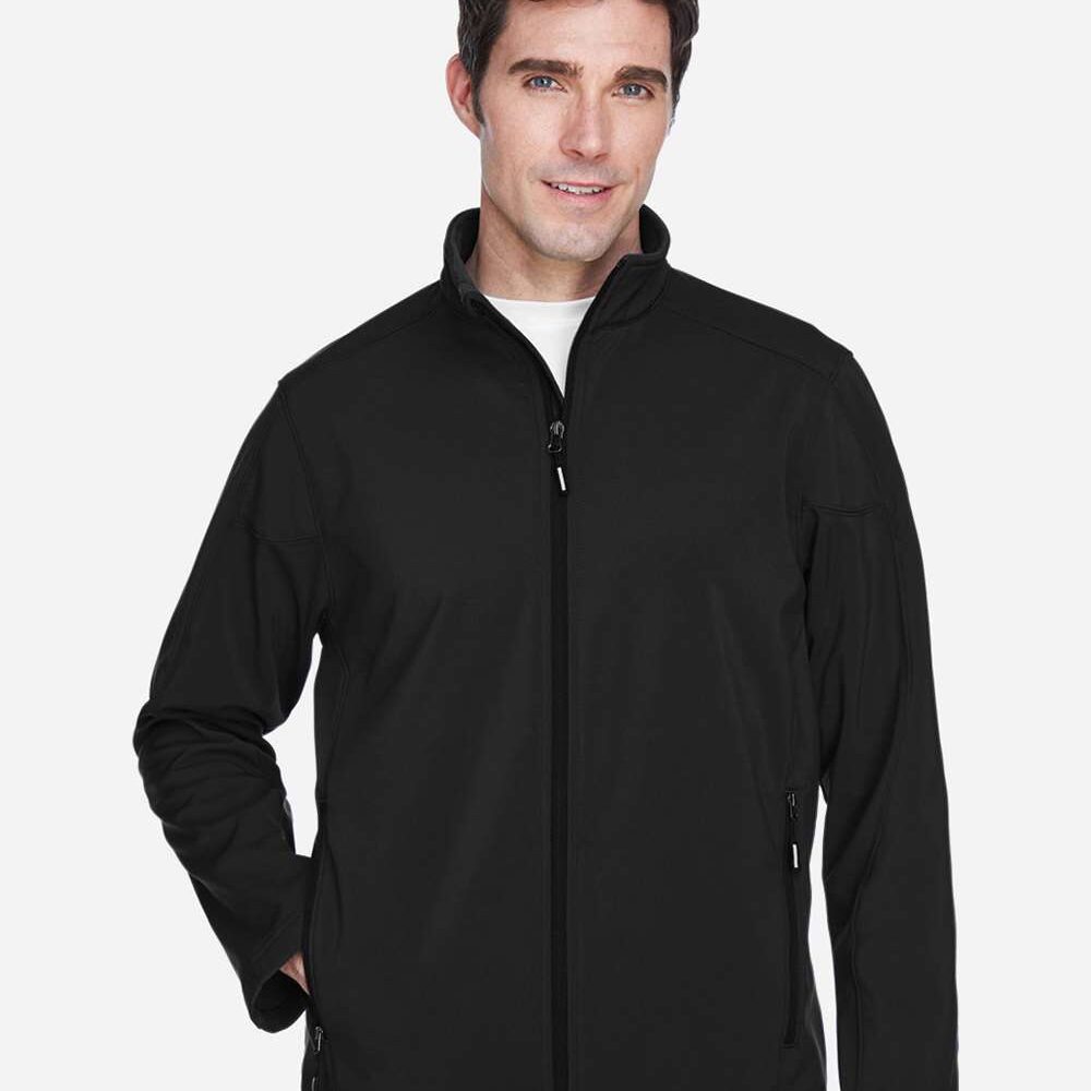 Man in black zippered softshell jacket with white t-shirt and khaki pants