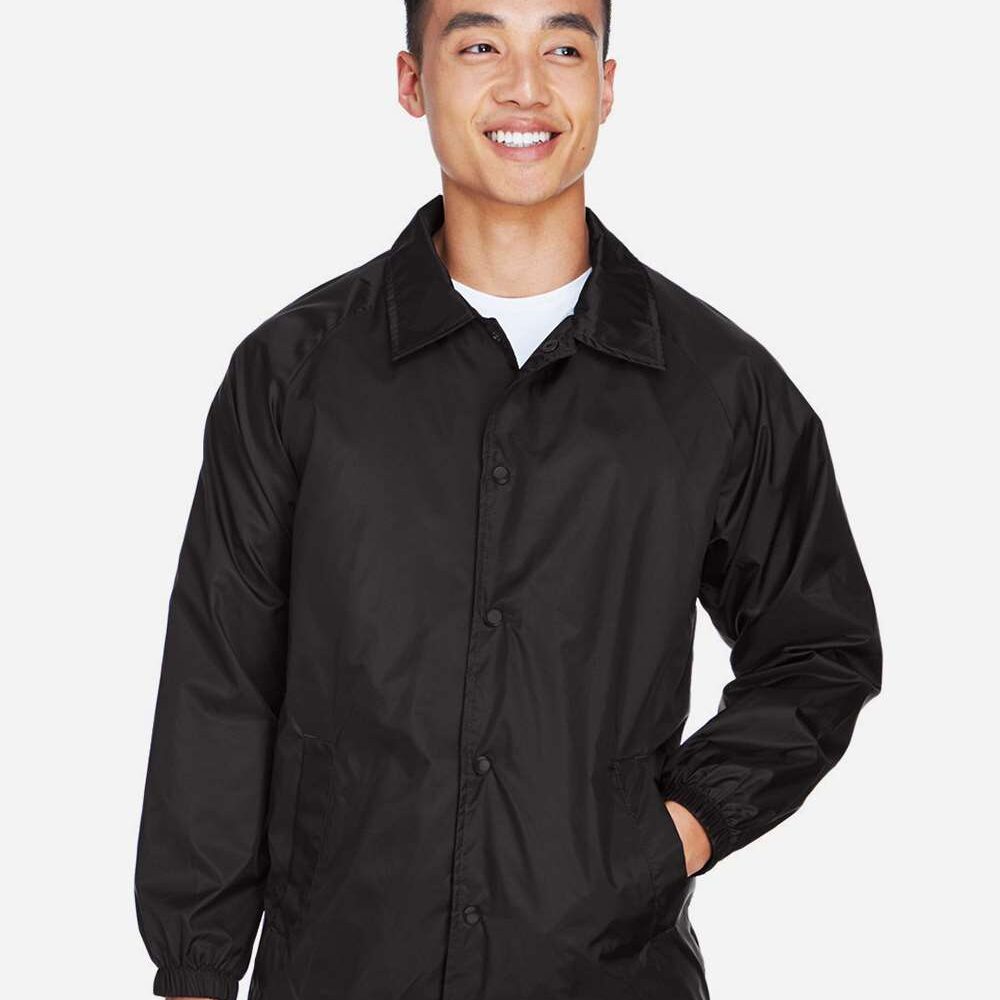 Man in black snap-front coach jacket with collared neckline and front pockets