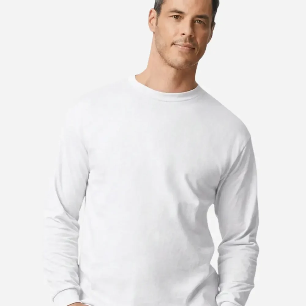 Man in white long sleeve t shirt with hands in pockets