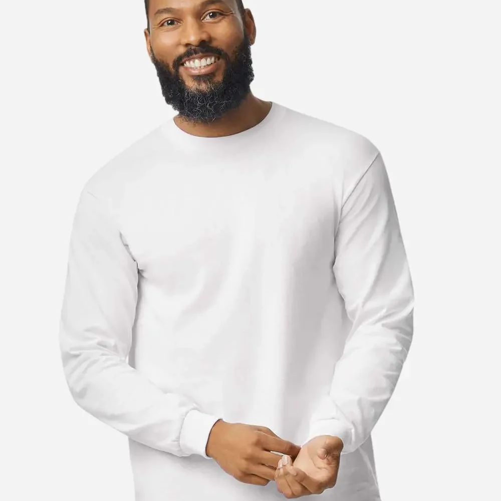 Man in white long-sleeve t-shirt smiling, arms crossed