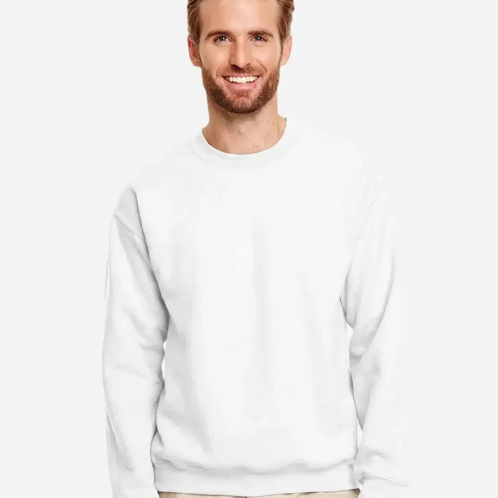 Smiling man wearing a plain white crewneck sweatshirt and khaki pants.