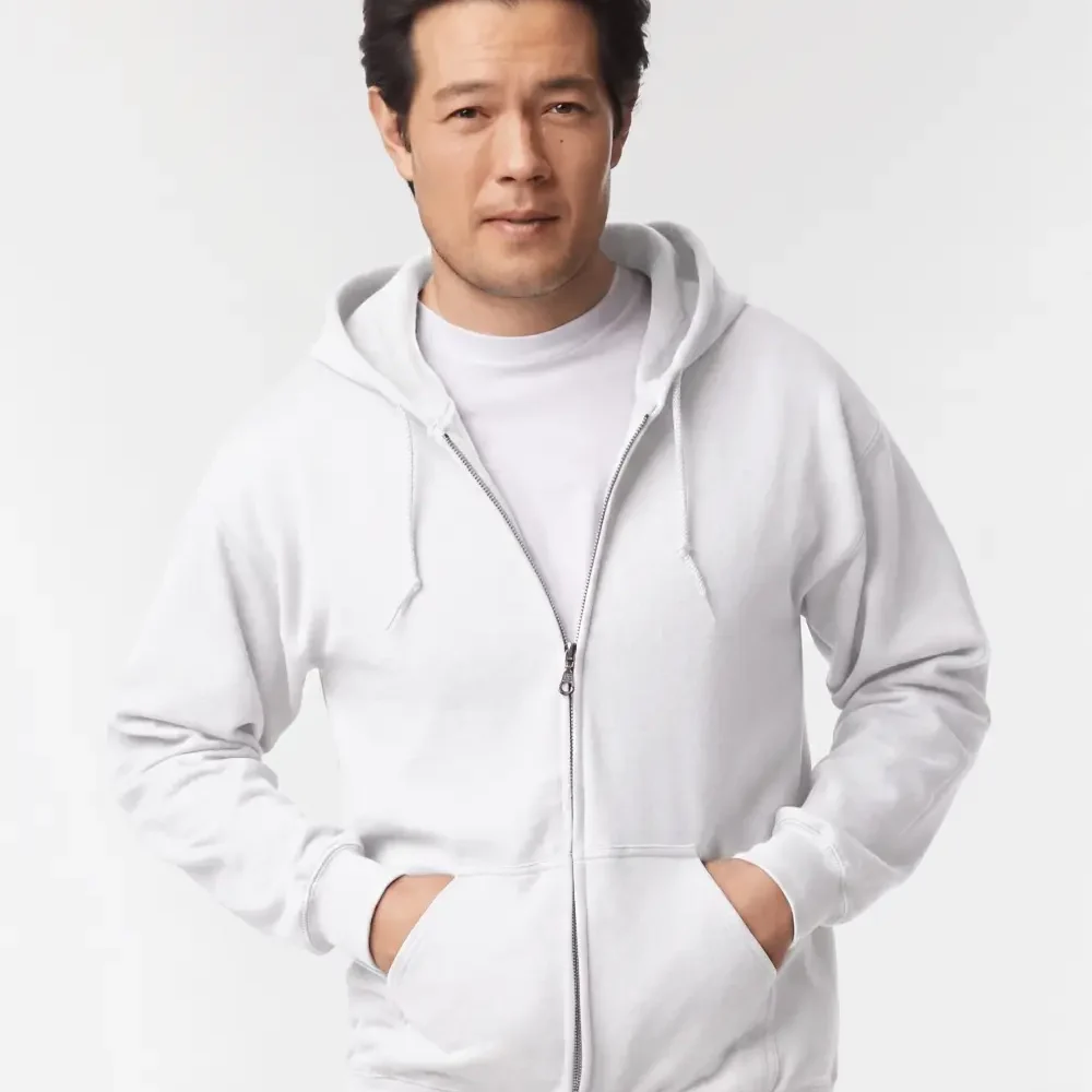 Man wearing white zip-up hoodie with hands in pockets