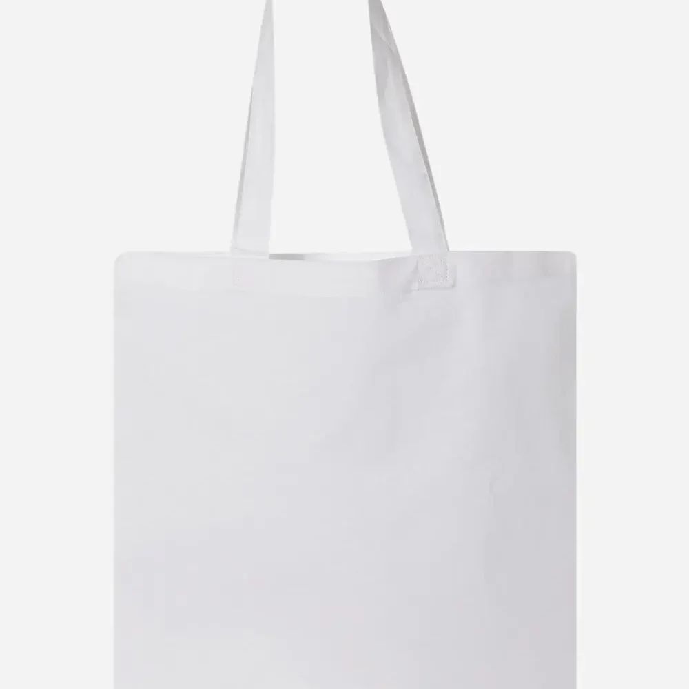 White canvas tote bag with fabric handles.