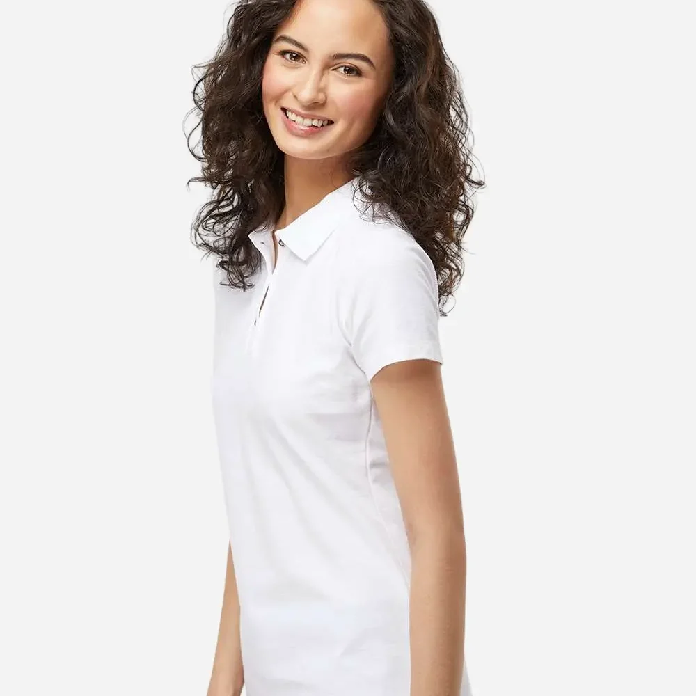 Woman smiling in a white short-sleeve polo shirt