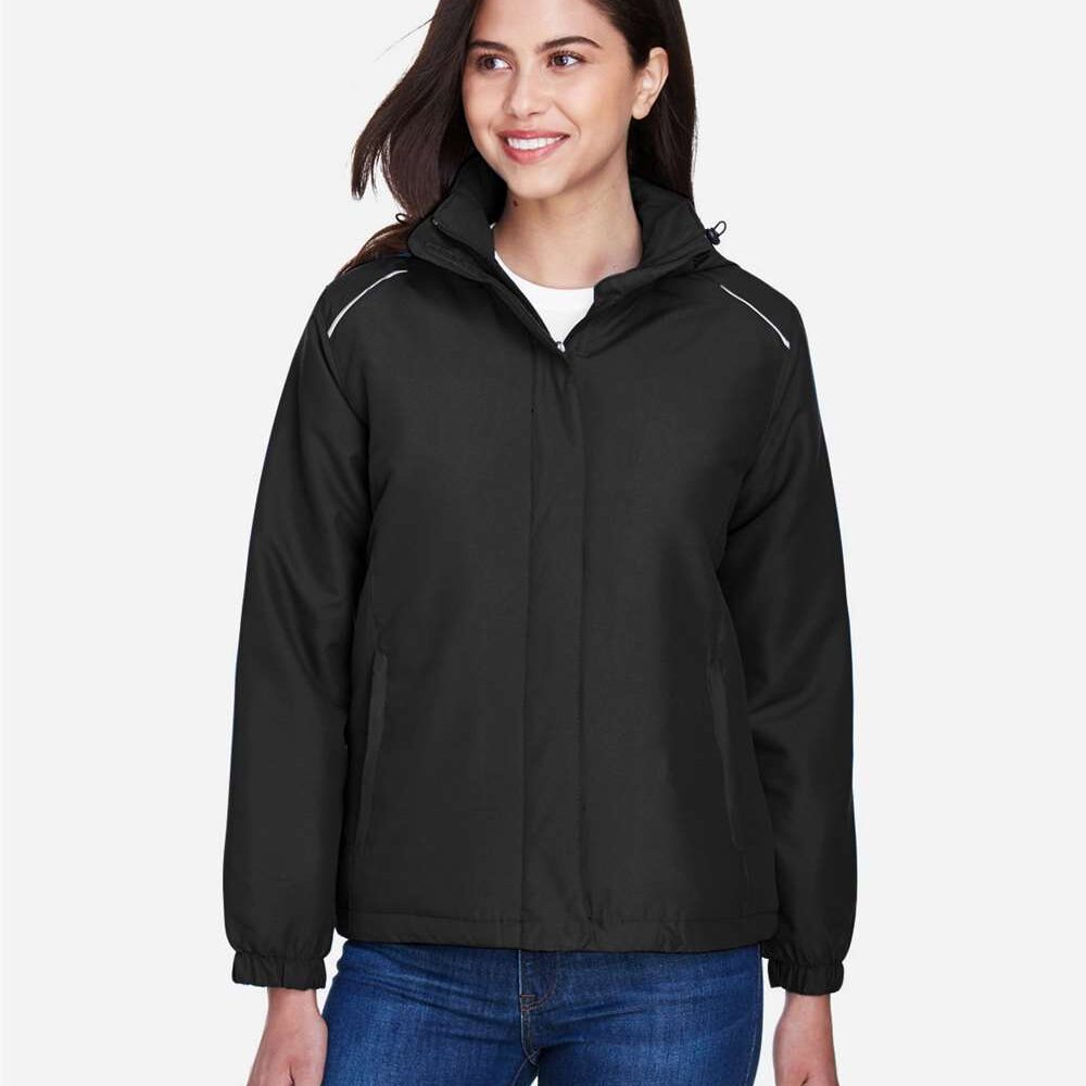 Woman wearing a black insulated jacket with reflective trim and blue jeans