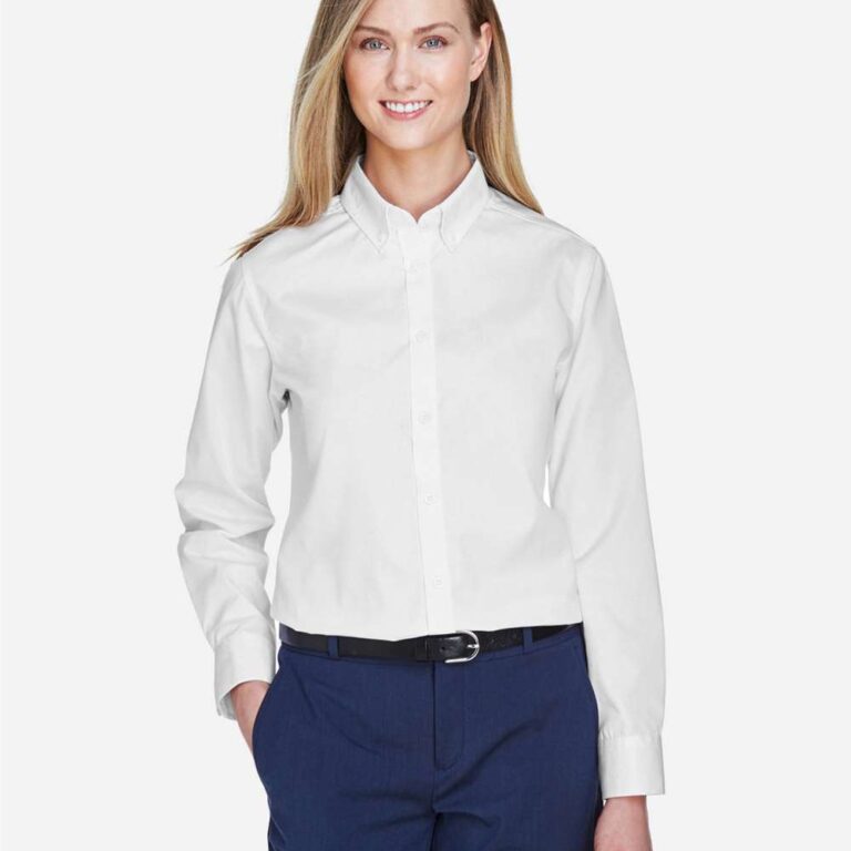 Woman in white button-up shirt and navy trousers with black belt