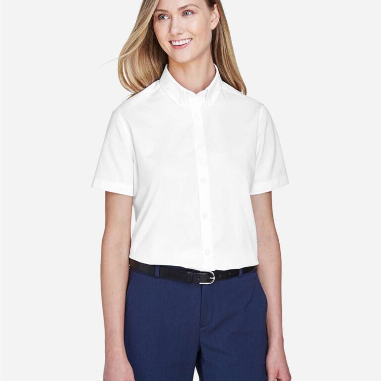 Woman in white short-sleeve button-up shirt and navy dress pants with black belt