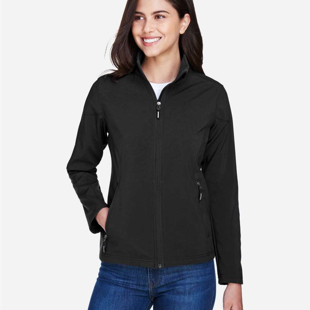 Woman wearing a black zip-up softshell jacket and blue jeans