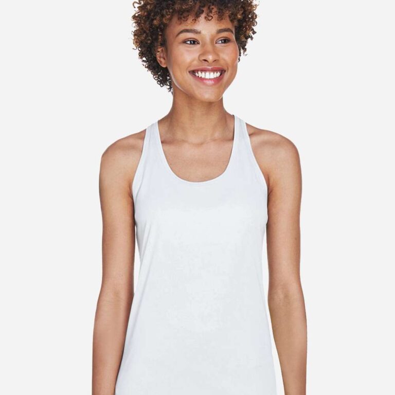Woman in white racerback tank top smiles broadly on a white background