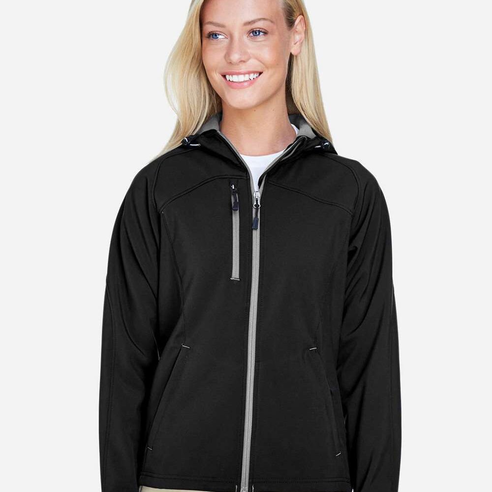 Woman wearing a black hooded softshell jacket with grey zipper accents