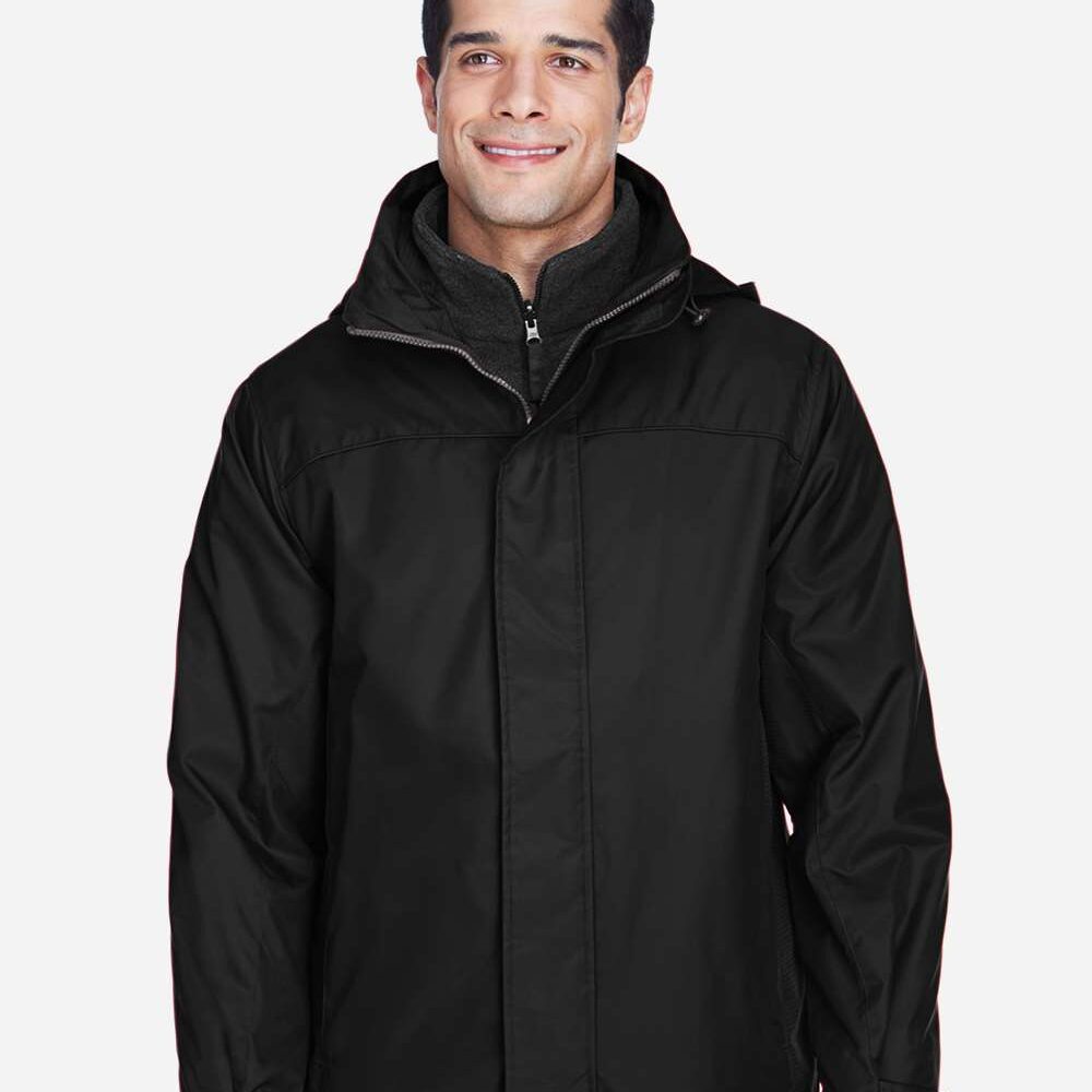 Man wearing black waterproof jacket with grey inner fleece and hood.