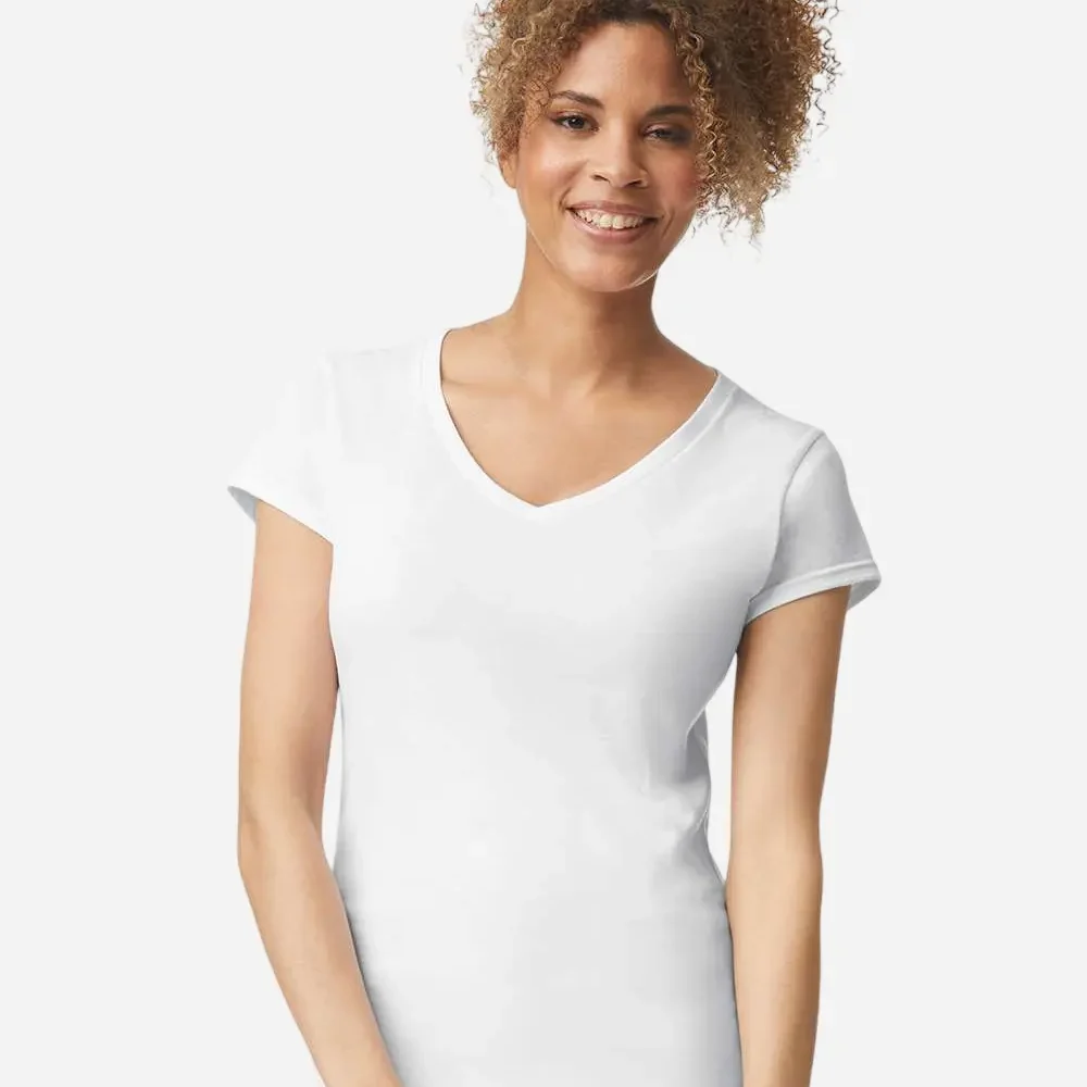 Woman wearing a plain white v-neck t-shirt and jeans, smiling against a white background