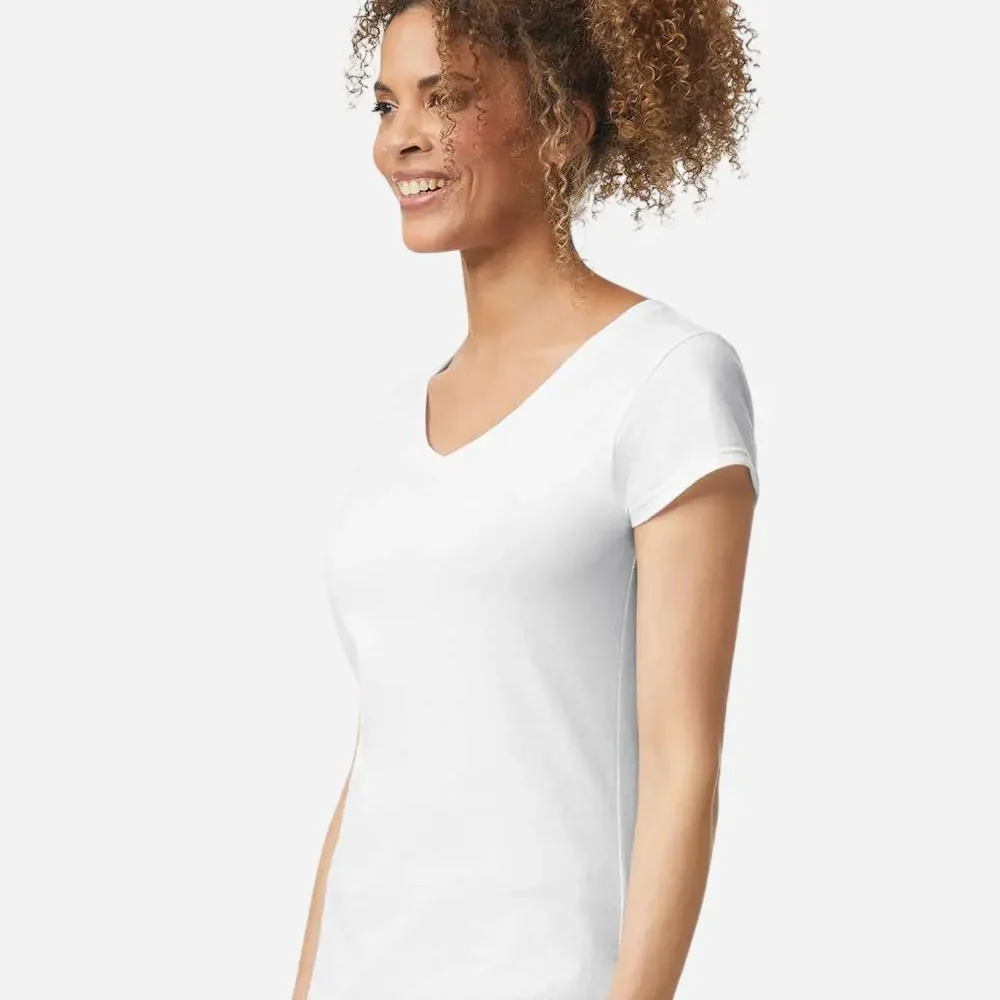 Woman wearing a plain white v-neck t-shirt and jeans, smiling and looking left
