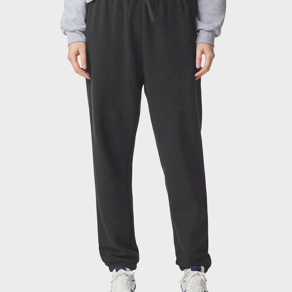 Model wearing black sweatpants and white athletic shoes