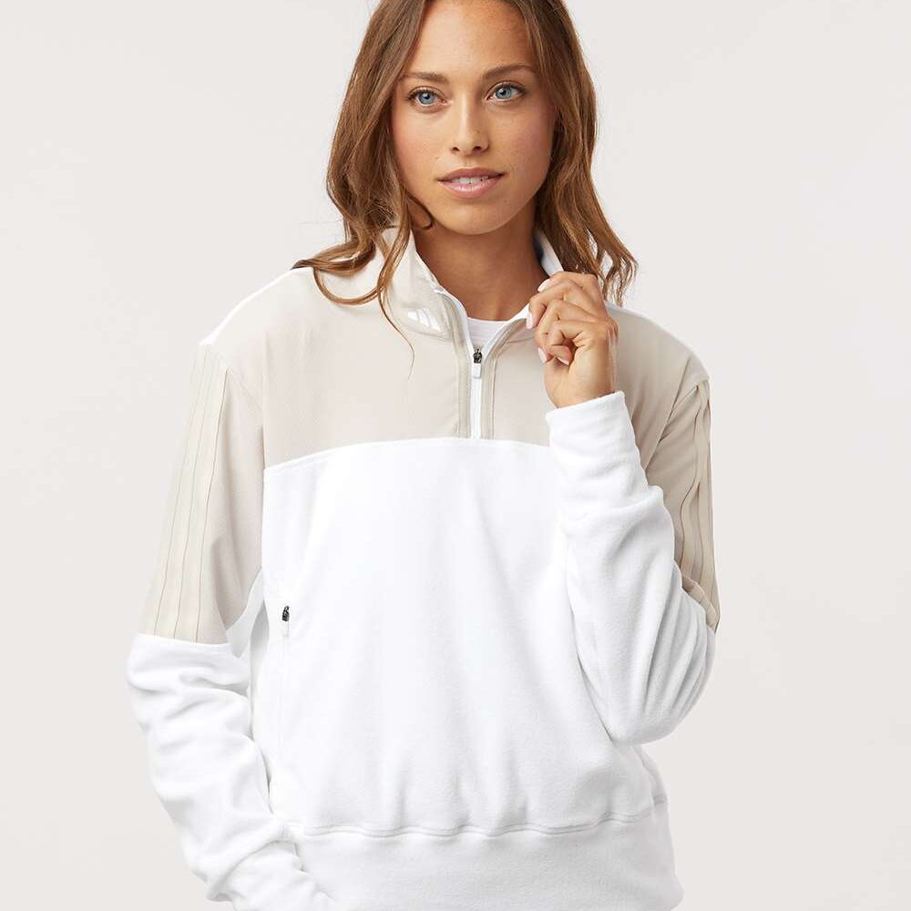Woman wearing Adidas colourblock quarter-zip sweatshirt and black leggings