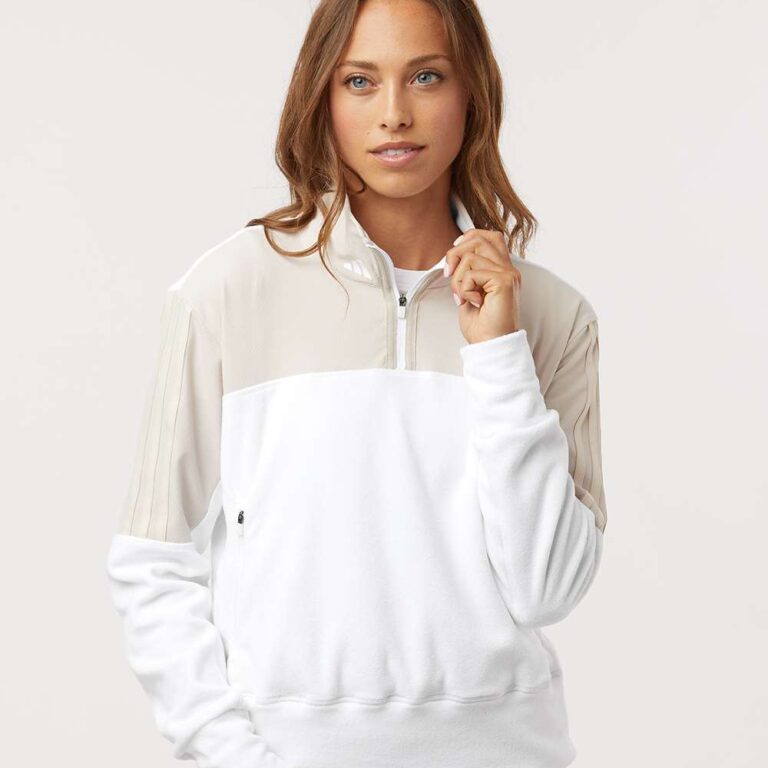 Woman wearing Adidas colourblock quarter-zip sweatshirt and black leggings