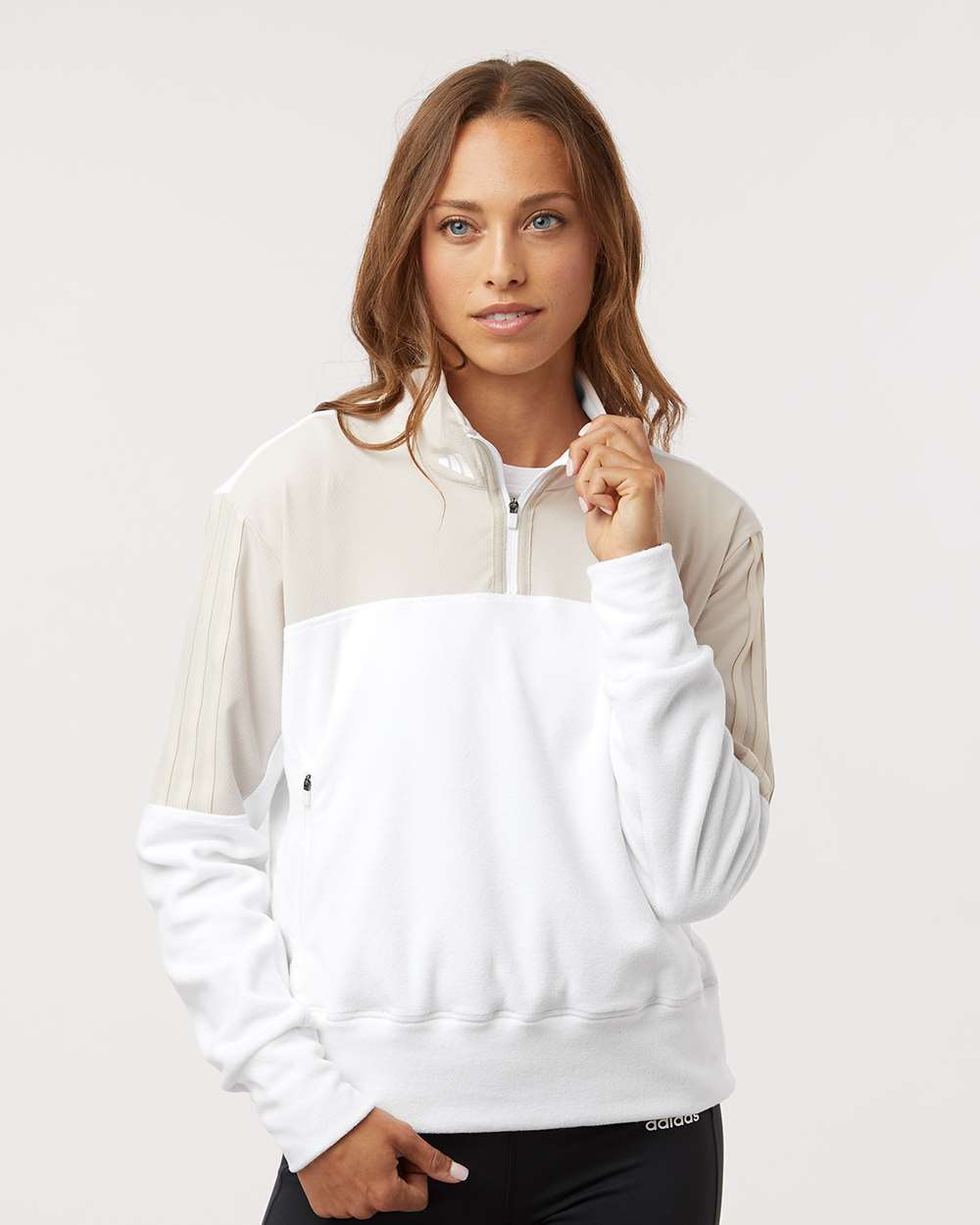 Woman wearing Adidas colourblock quarter-zip sweatshirt and black leggings