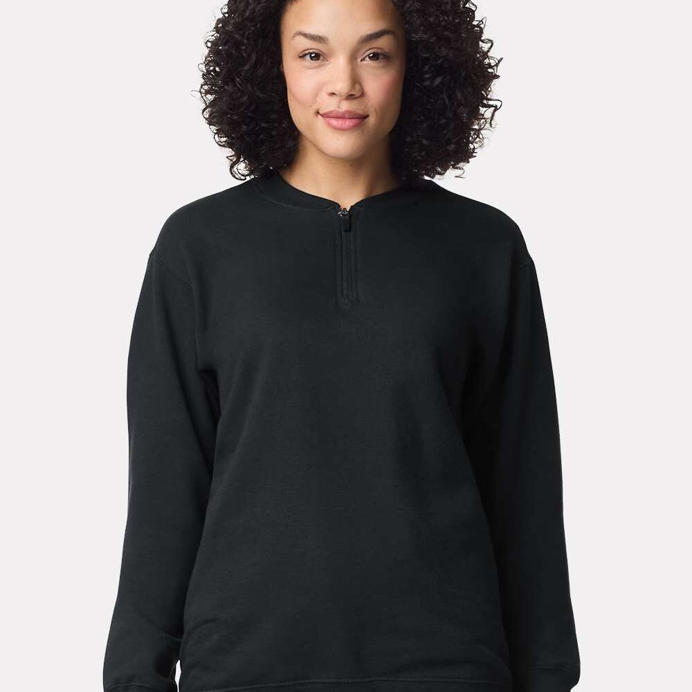 Woman wearing a black quarter zip sweatshirt.