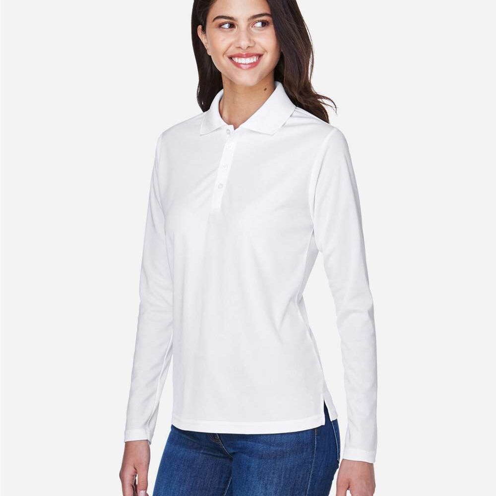 Woman wearing a white long sleeve polo shirt and blue jeans