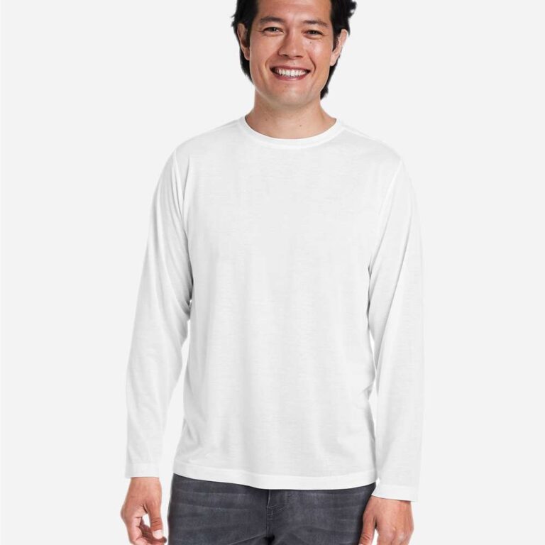 Man in white long sleeve shirt and grey jeans smiles at camera
