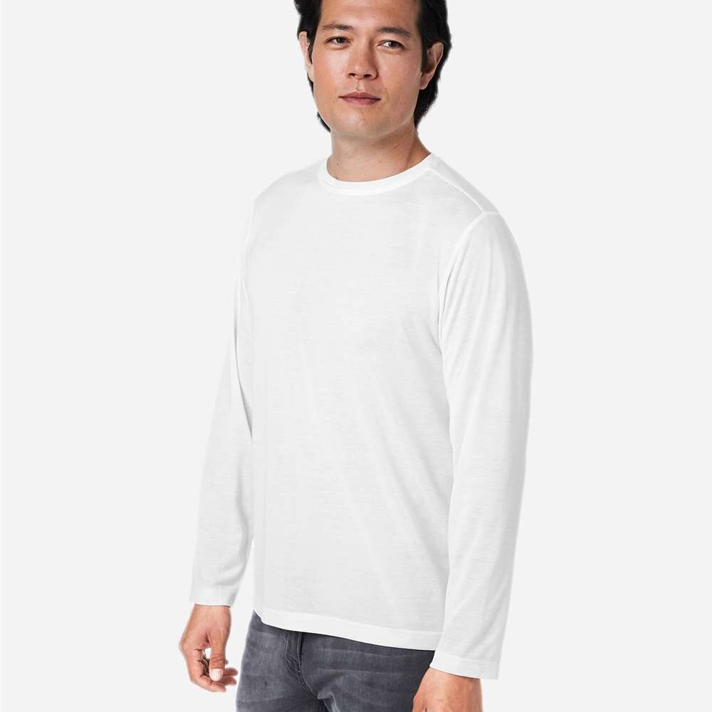 Man wearing a white long-sleeved shirt and grey jeans.