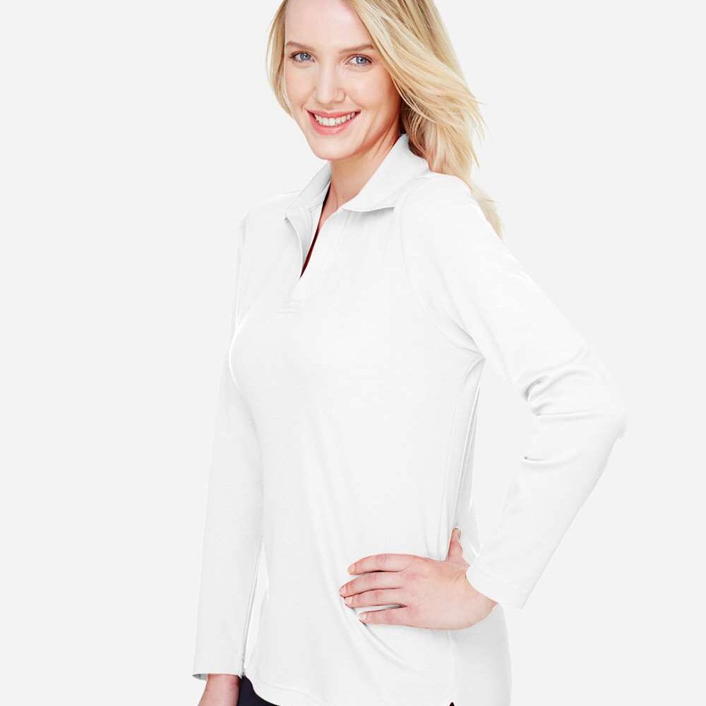 Woman wearing a white long-sleeve polo shirt with a hand on her hip
