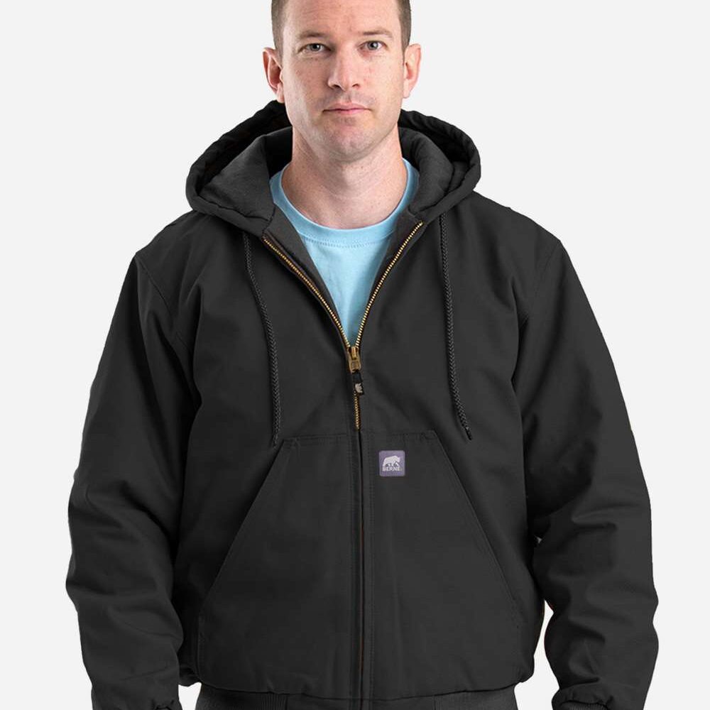 Man wearing a black hooded Carhartt jacket with a blue t-shirt.