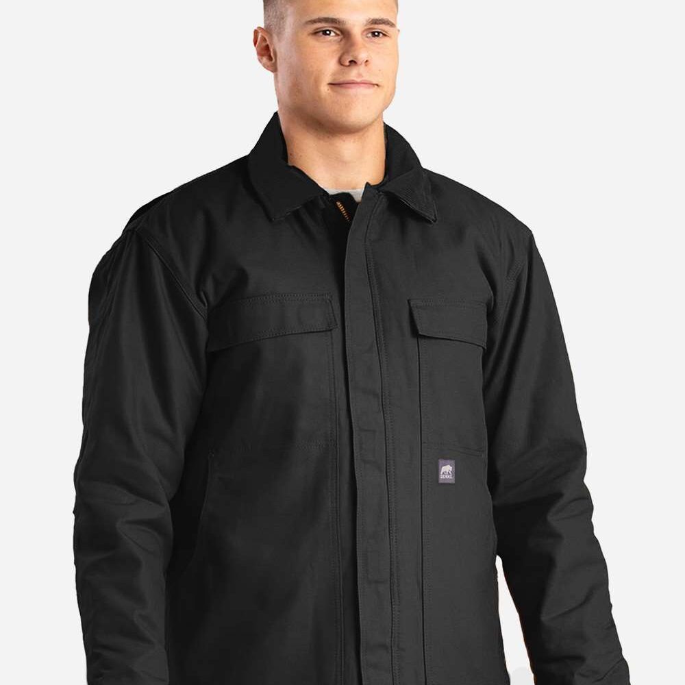 Man wearing black canvas work jacket with chest and hand pockets.
