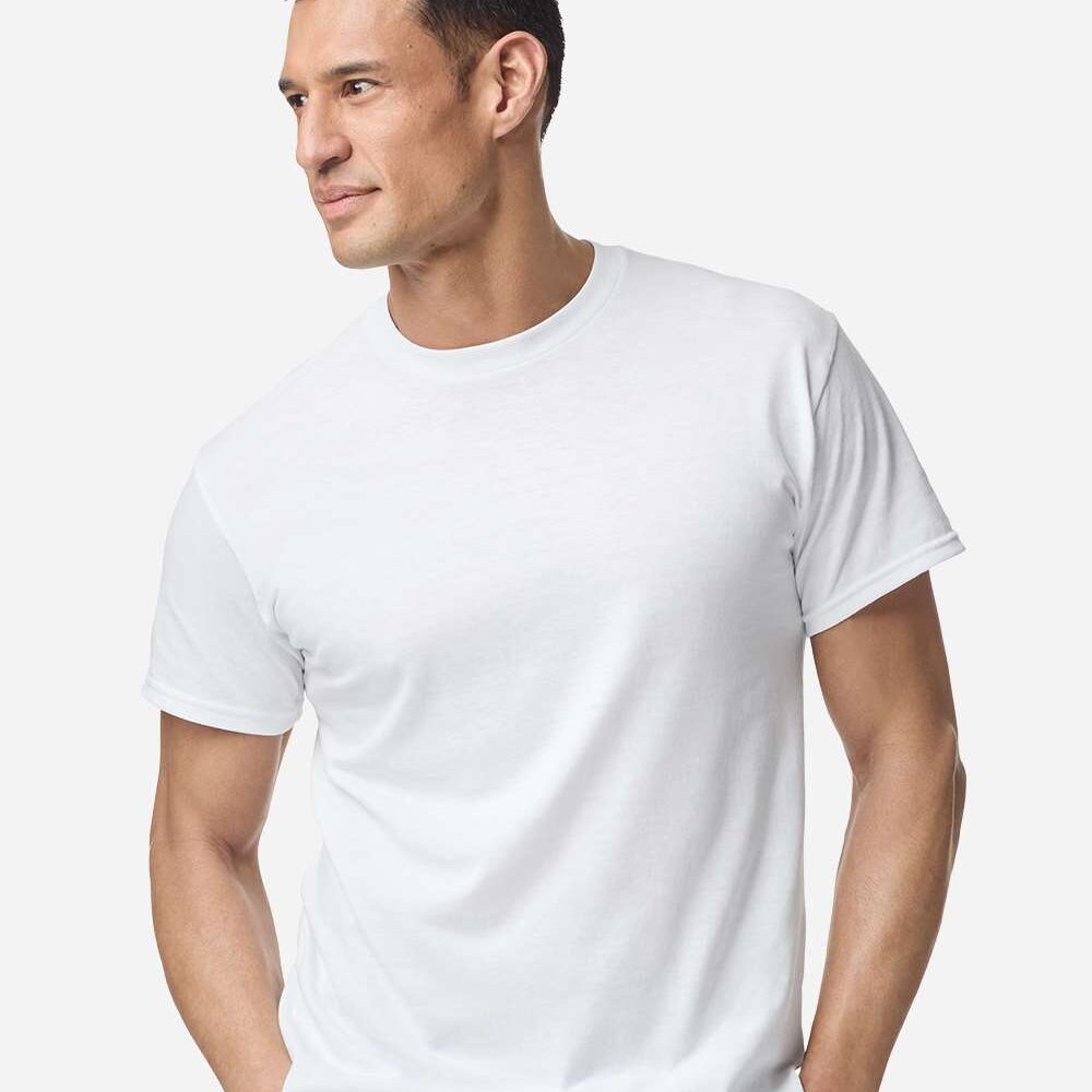 Man wearing a white t shirt with hands in pockets