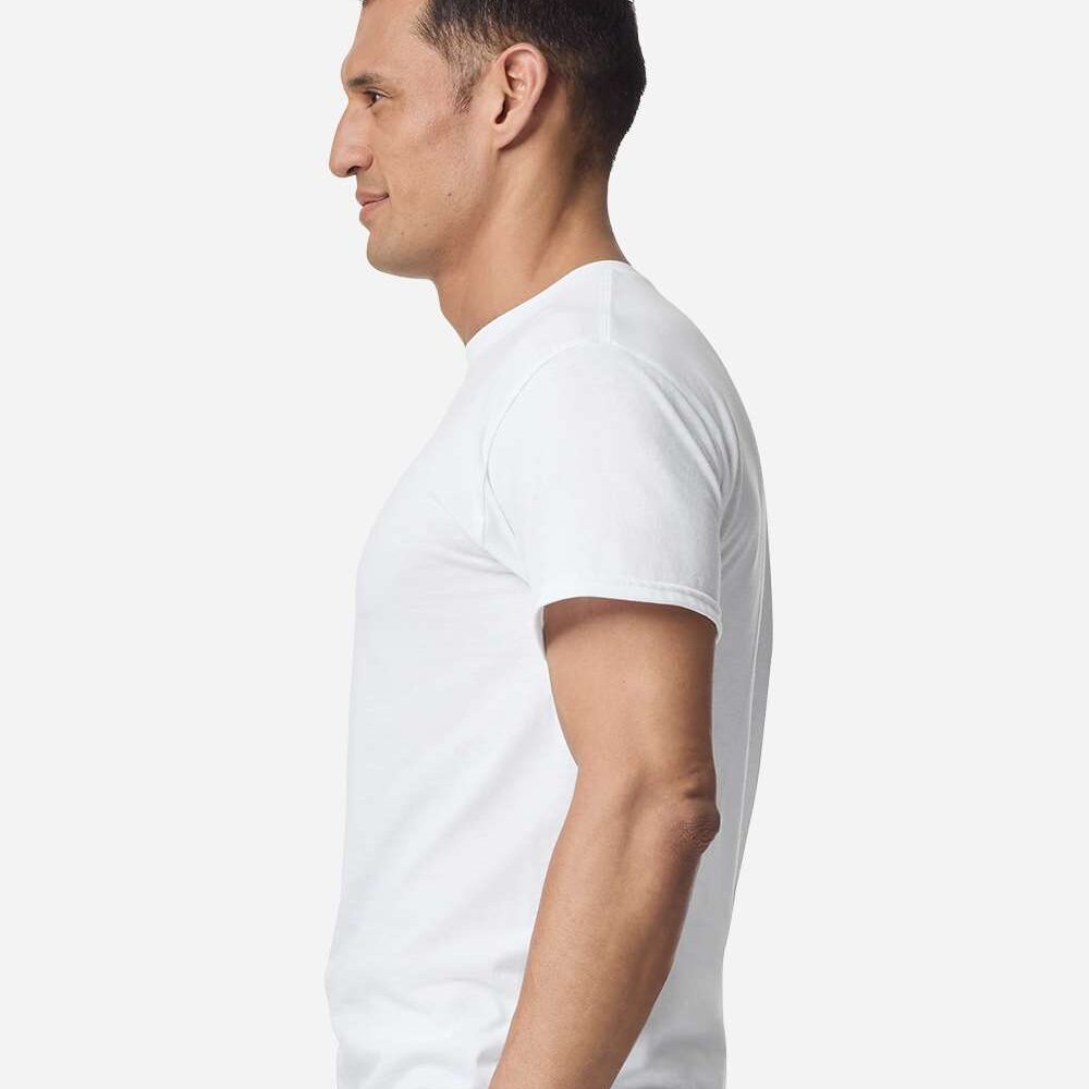 Man in white t-shirt and grey pants profile view