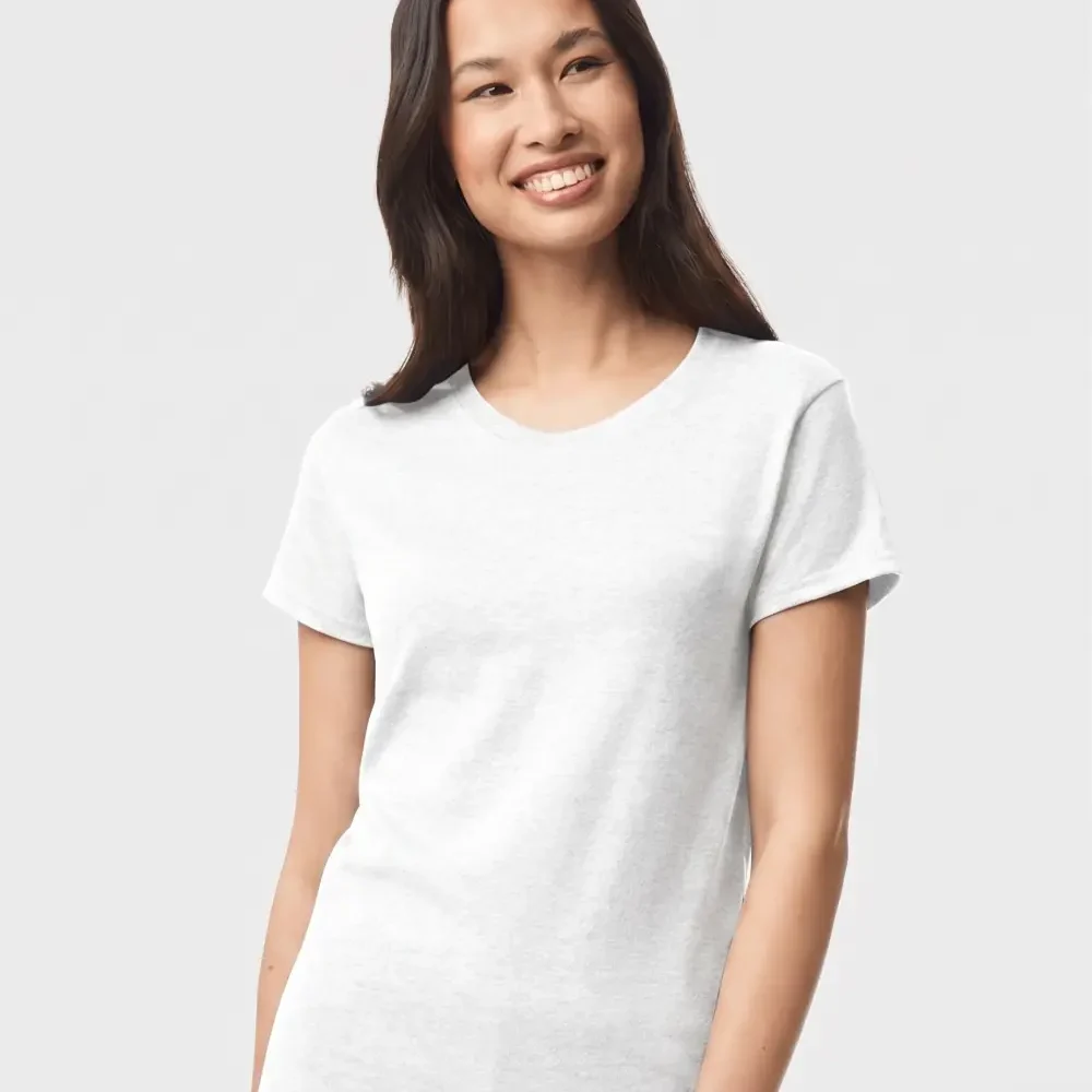 Woman wearing a plain white t-shirt and navy blue pants, smiling.