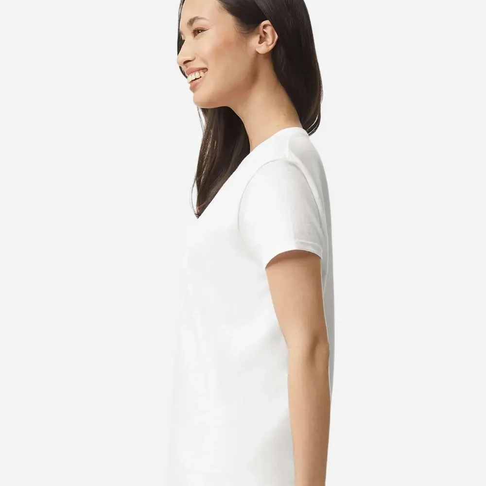 Woman wearing a white t-shirt and blue jeans, smiling.