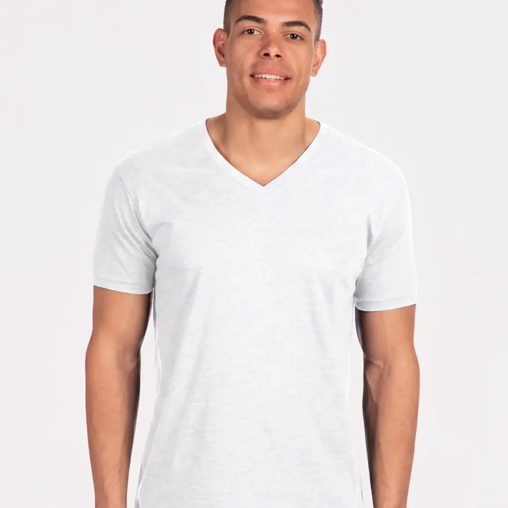 Man wearing a white V-neck t-shirt and blue jeans smiling