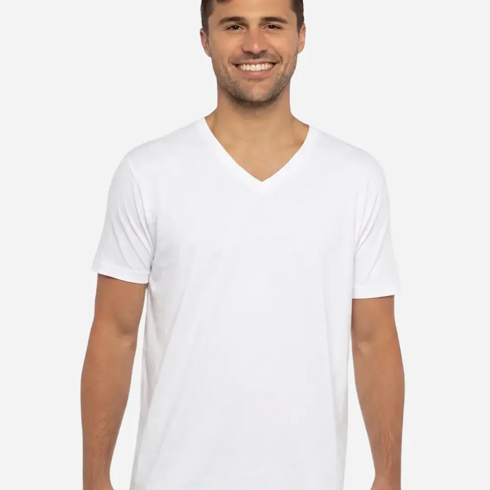 Man in white v-neck t-shirt smiling against a light grey background.