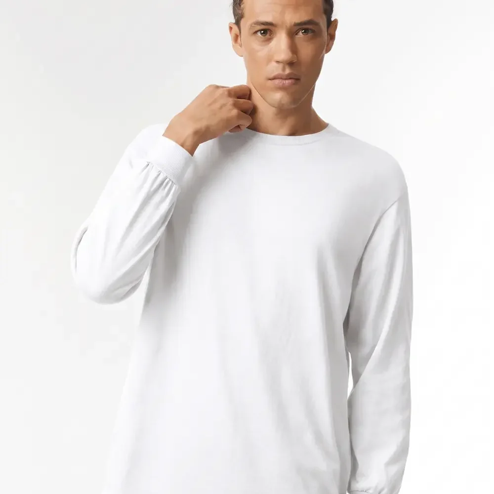 Man in white long-sleeve t-shirt with braids, hand touching neck.