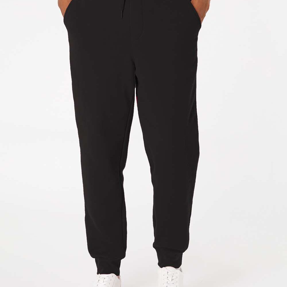 Black jogger pants with drawstring waist and white sneakers