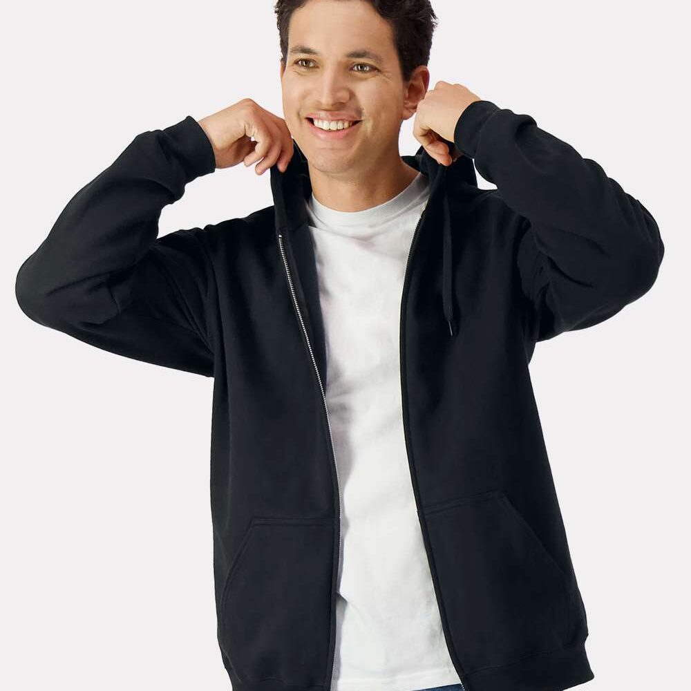 Man wearing a black zippered hoodie and blue jeans