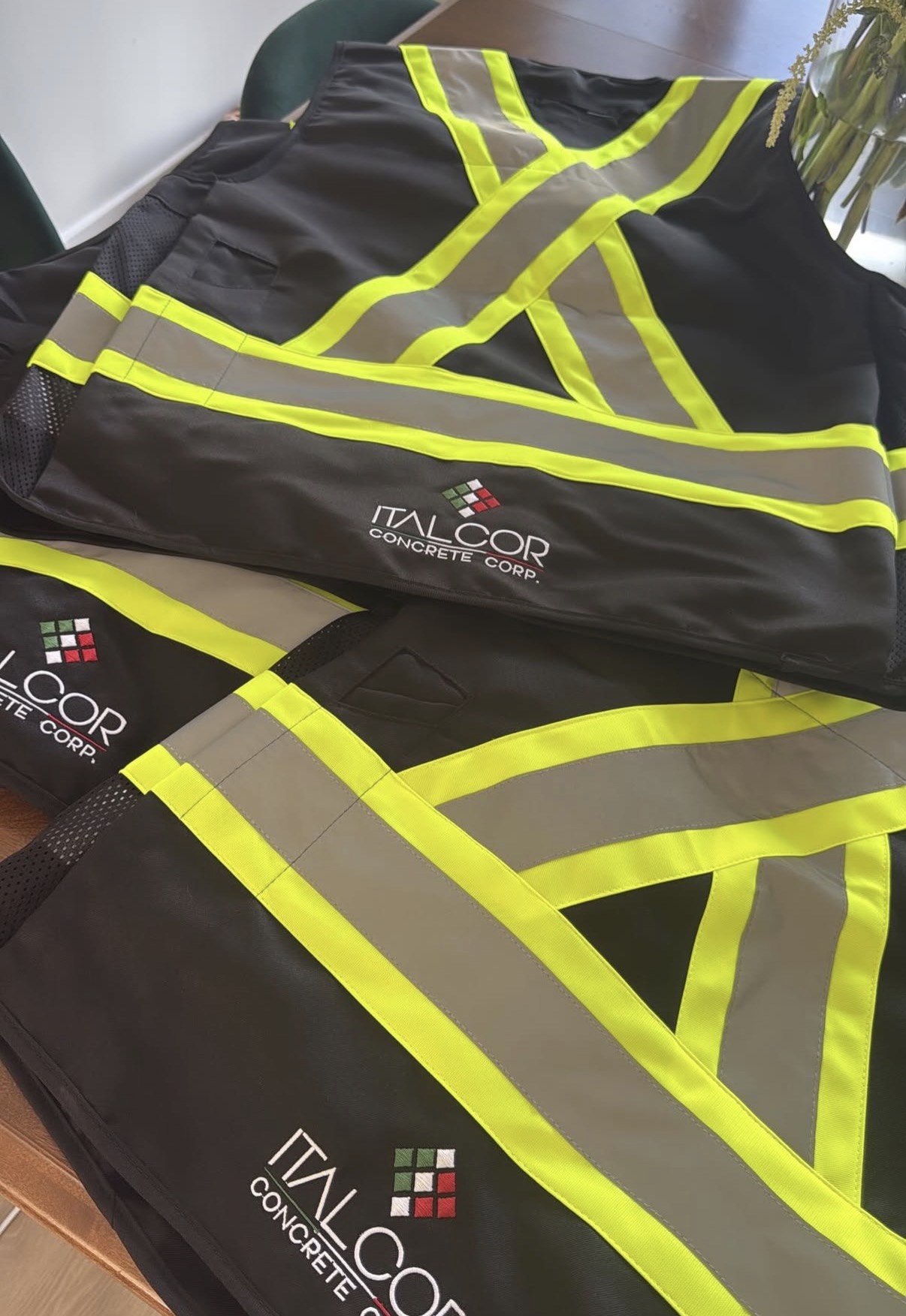 High-visibility safety vests with Italcor Concrete Corp. logo.