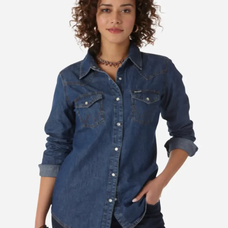 Woman in blue denim western shirt with rolled up sleeves and dark jeans